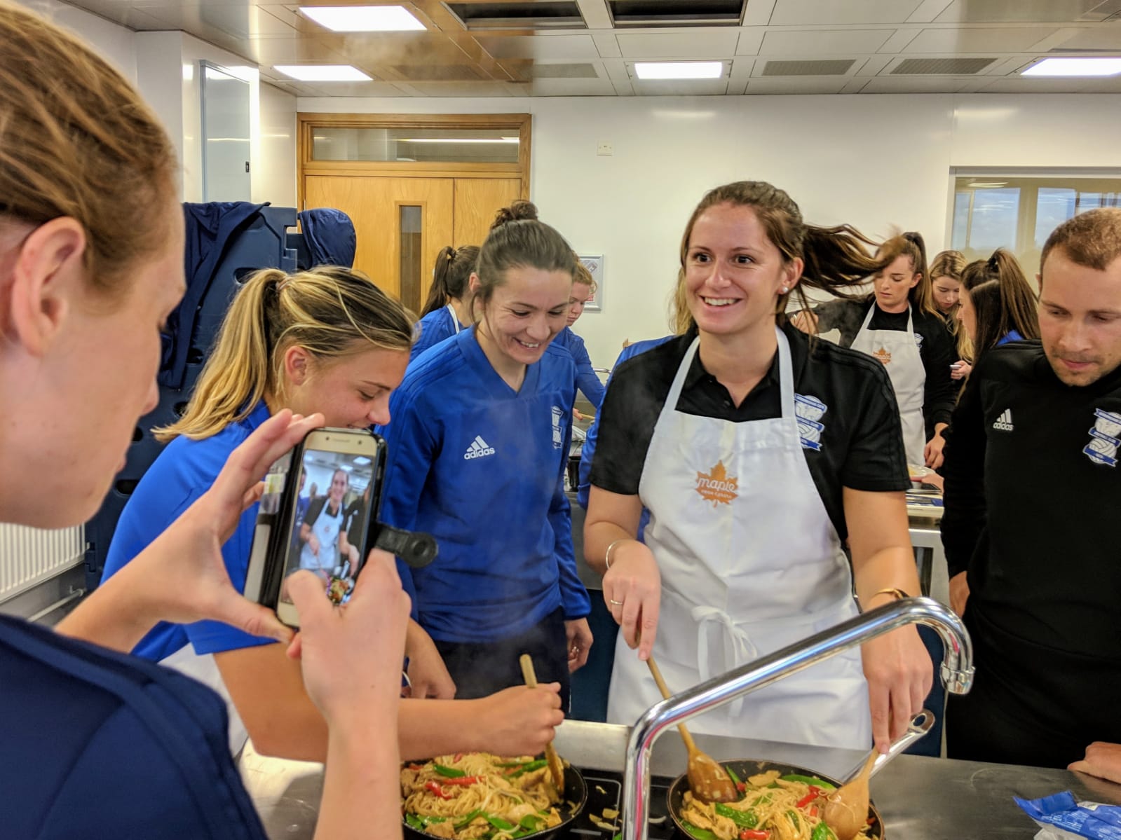 Birmingham City Ladies Fc players preparing the teriyaki stir fry